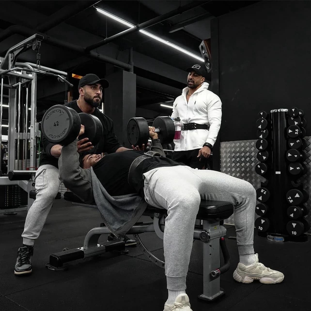 Coach Hassan Ibrahim coaching a client in the gym